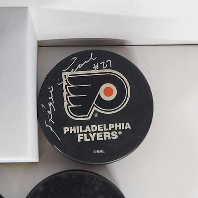 LOT 93: Many Autographed Hockey Pucks by Various Players from Philadelphia Flyers, New Jersey Devils and More