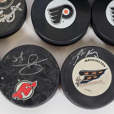 LOT 93: Many Autographed Hockey Pucks by Various Players from Philadelphia Flyers, New Jersey Devils and More