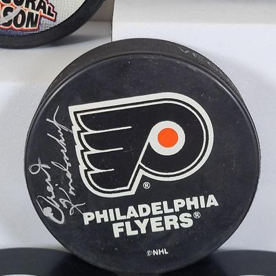 LOT 93: Many Autographed Hockey Pucks by Various Players from Philadelphia Flyers, New Jersey Devils and More