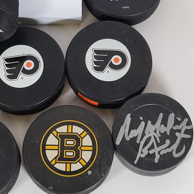 LOT 93: Many Autographed Hockey Pucks by Various Players from Philadelphia Flyers, New Jersey Devils and More