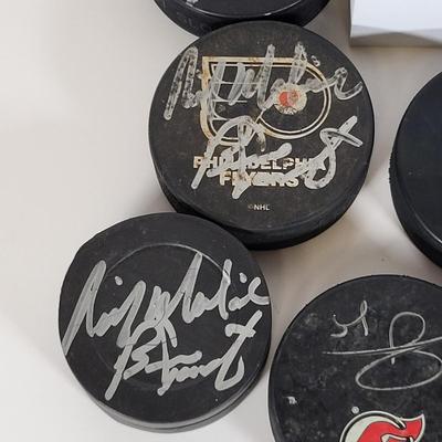 LOT 93: Many Autographed Hockey Pucks by Various Players from Philadelphia Flyers, New Jersey Devils and More