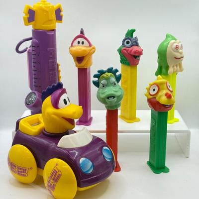 LOT 135: PEZ Collection: Flashlight, Toy Car, Monster Head Dispensers