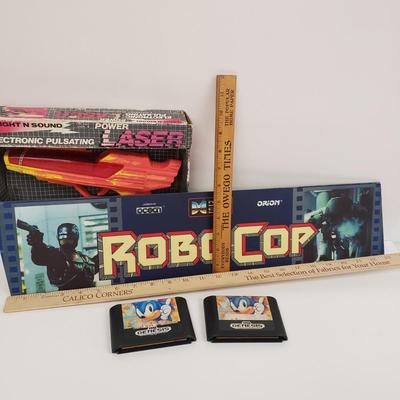 LOT 150: Robocop Glass Arcade Marquee, 2 Sonic Sega Games, Vintage Laser Gun