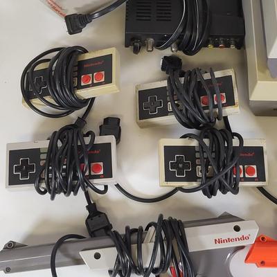 LOT 163: Two Original Vintage Nintendo NES Systems with Controllers, Duck Hunt Guns and More