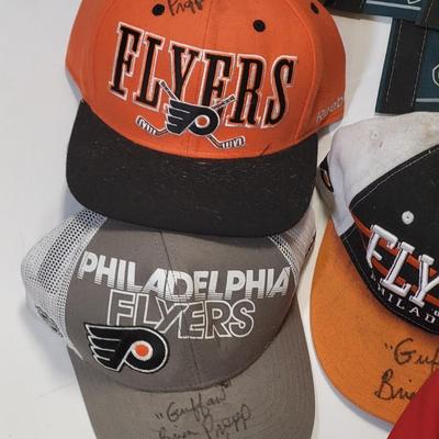 LOT 165: Philadelphia Sports Memorabilia Including Autographed Hats of Jon Runyan, Brian Propp and More