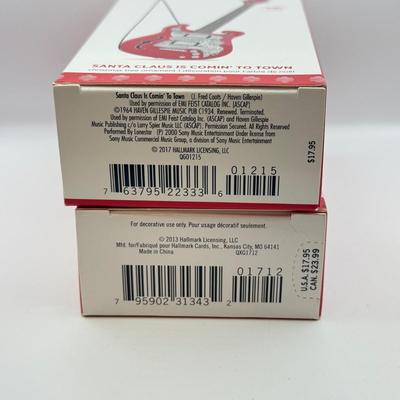 LOT 175: Hallmark Keepsake Magic Guitar Ornaments in Boxes: We Wish You a Merry Christmas & Santa Claus is Comin' to Town