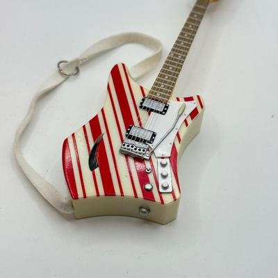 LOT 175: Hallmark Keepsake Magic Guitar Ornaments in Boxes: We Wish You a Merry Christmas & Santa Claus is Comin' to Town