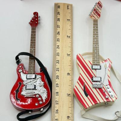 LOT 175: Hallmark Keepsake Magic Guitar Ornaments in Boxes: We Wish You a Merry Christmas & Santa Claus is Comin' to Town