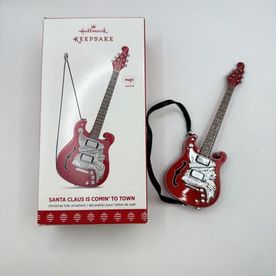 LOT 175: Hallmark Keepsake Magic Guitar Ornaments in Boxes: We Wish You a Merry Christmas & Santa Claus is Comin' to Town