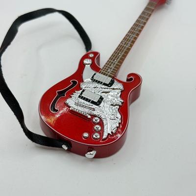 LOT 175: Hallmark Keepsake Magic Guitar Ornaments in Boxes: We Wish You a Merry Christmas & Santa Claus is Comin' to Town