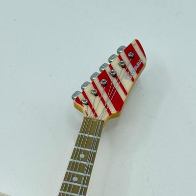 LOT 175: Hallmark Keepsake Magic Guitar Ornaments in Boxes: We Wish You a Merry Christmas & Santa Claus is Comin' to Town
