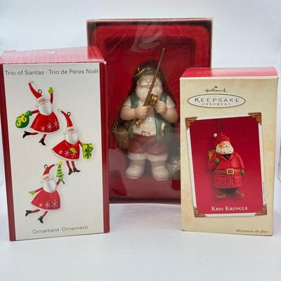 LOT 178: Lenox Fishing Santa, Hallmark Keepsake Ornament Kris Kringle & Trio of Santas all in Boxes