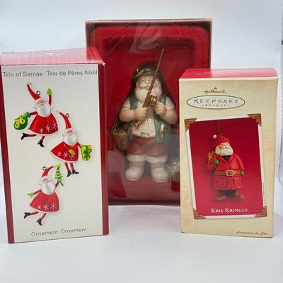 LOT 178: Lenox Fishing Santa, Hallmark Keepsake Ornament Kris Kringle & Trio of Santas all in Boxes