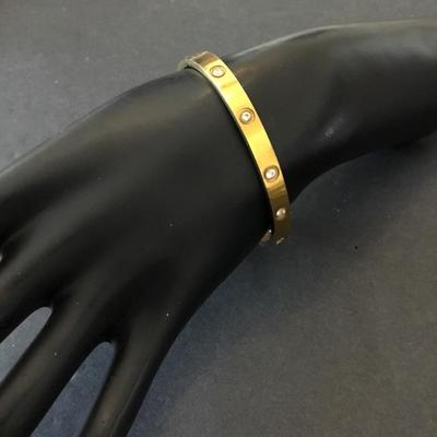 Gold tone locking bracelet