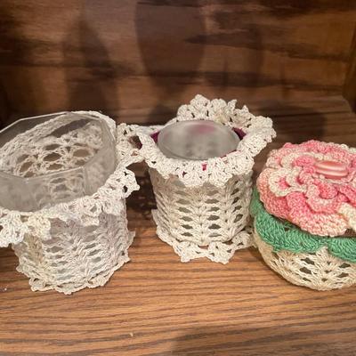 Candles and salt and pepper shakers, along with some crocheted decor
