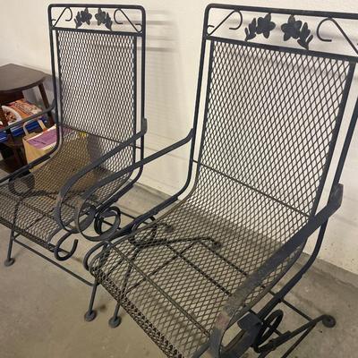 Two black metal rocking chairs