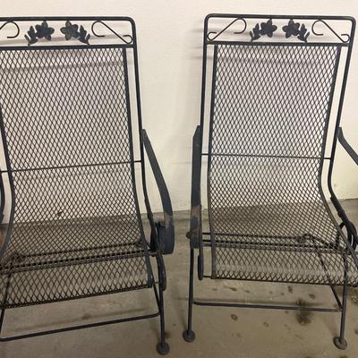 Two black metal rocking chairs