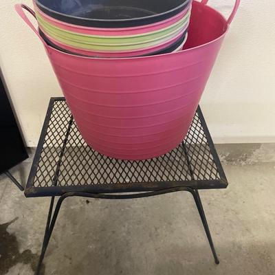 Black metal outdoor table with plastic planters