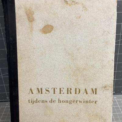 Sale Photo Thumbnail #159: Published only two years after Holland’s liberation from the Nazis, with over a 100 photos and an introduction by Max Nord..."AMSTERDAM tijdens de hongerwinter 1944-45" (AMSTERDAM during the hunger winter 1944-45)...Detailing the harsh winter and Gaeman