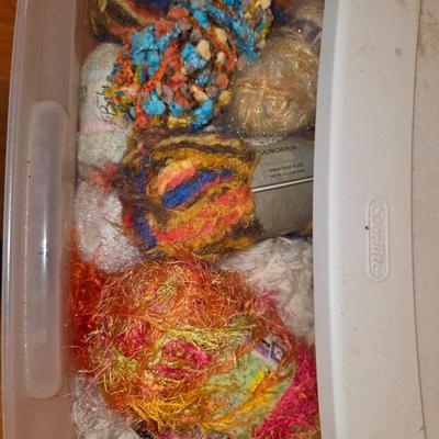 Storage bin packed with yarns