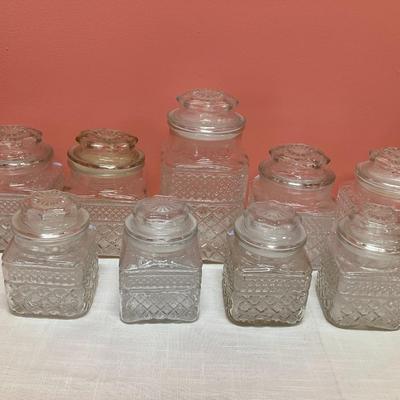 Sale Photo Thumbnail #17: 9 glass canisters with lids. See pictures for approx measurements. No chips/cracks.
