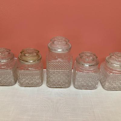 Sale Photo Thumbnail #15: 9 glass canisters with lids. See pictures for approx measurements. No chips/cracks.