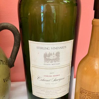 Sale Photo Thumbnail #27: 3 items: 1 oversized glass wine bottle, 1 pottery vase, 1 wooden carved wine bottle. Great decor pieces.