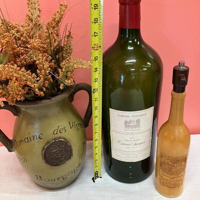 Sale Photo Thumbnail #29: 3 items: 1 oversized glass wine bottle, 1 pottery vase, 1 wooden carved wine bottle. Great decor pieces.