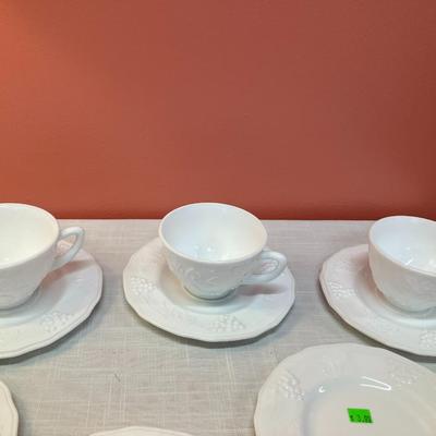 Sale Photo Thumbnail #54: Set of same pattern milk glass items, containing: 6 small plates, 5 cups, 3 saucers, all in excellent condition