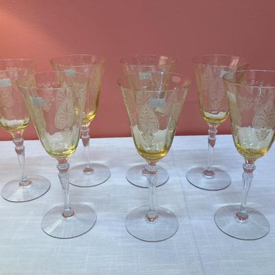 Sale Photo Thumbnail #70: Amazing pieces of Trojan Topaz designed Fostoria glassware, produced 1929-1936. Gorgeous yellow topaz color and clarity. Some pieces may have minor chips due to age. Gorgeous etched design. 
Set includes: 7 wine glasses