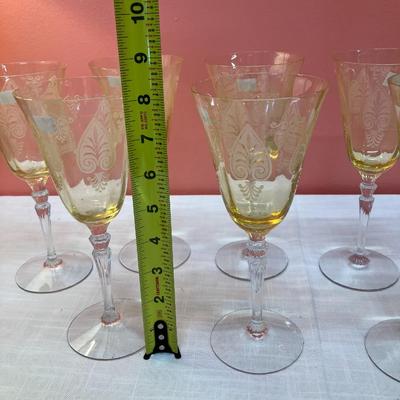 Sale Photo Thumbnail #72: Amazing pieces of Trojan Topaz designed Fostoria glassware, produced 1929-1936. Gorgeous yellow topaz color and clarity. Some pieces may have minor chips due to age. Gorgeous etched design. 
Set includes: 7 wine glasses