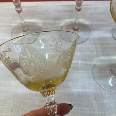 Sale Photo Thumbnail #76: Amazing pieces of Trojan Topaz designed Fostoria glassware, produced 1929-1936. Gorgeous yellow topaz color and clarity. Some pieces may have minor chips due to age. Gorgeous etched design. 
Set includes: 5 martini glasses
