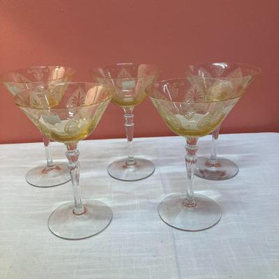 Sale Photo Thumbnail #73: Amazing pieces of Trojan Topaz designed Fostoria glassware, produced 1929-1936. Gorgeous yellow topaz color and clarity. Some pieces may have minor chips due to age. Gorgeous etched design. 
Set includes: 5 martini glasses