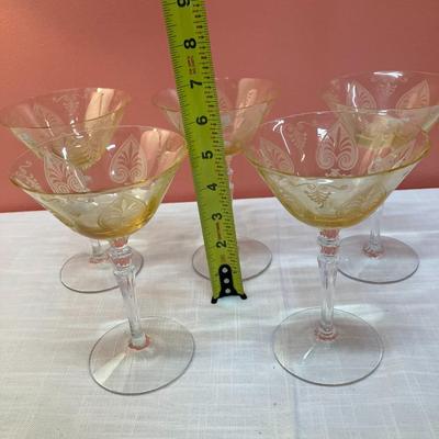 Sale Photo Thumbnail #74: Amazing pieces of Trojan Topaz designed Fostoria glassware, produced 1929-1936. Gorgeous yellow topaz color and clarity. Some pieces may have minor chips due to age. Gorgeous etched design. 
Set includes: 5 martini glasses