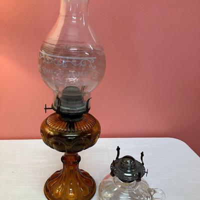 Sale Photo Thumbnail #98: Set includes amber colored oil lamp base with clear globe with white etching "Home Sweet Home" and an additional clear oil lamp base.