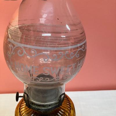 Sale Photo Thumbnail #99: Set includes amber colored oil lamp base with clear globe with white etching "Home Sweet Home" and an additional clear oil lamp base.