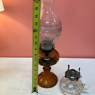Sale Photo Thumbnail #100: Set includes amber colored oil lamp base with clear globe with white etching "Home Sweet Home" and an additional clear oil lamp base.