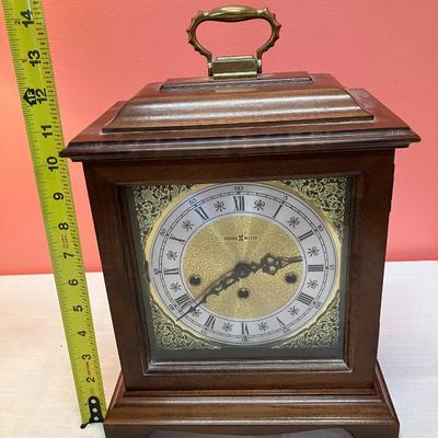 Sale Photo Thumbnail #129: This beautiful Howard Miller Bracket Mantel Clock works and is in excellent condition! Comes with winding key and original owners instructions.