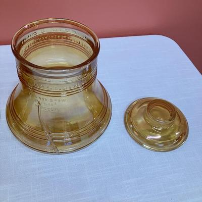Sale Photo Thumbnail #207: 1976 Bicentennial Liberty Bell liquor decanter and cookie jar. Decanter is amber colored glass. Cookie jar is amber colored glass with an iridescent finish.