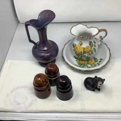Sale Photo Thumbnail #57: Purple pitcher, yellow flower picture and bowl, 3 brown insulators, bear figurine.