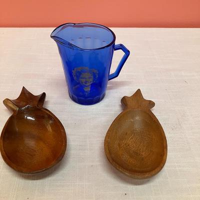 Sale Photo Thumbnail #222: Set of 2 small wooden pineapple bowls and a blue glass cream pitcher with a white etched image of Shirley Temple