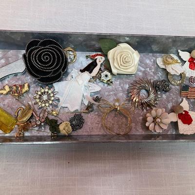 Sale Photo Thumbnail #256: Collection of 30 vintage brooches of various sizes and materials, and 1 vintage folding comb