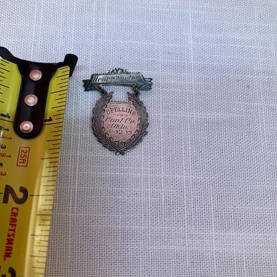 Sale Photo Thumbnail #273: Definitely a unique item! 1913 spelling bee pin with recipient's name engraved on it.