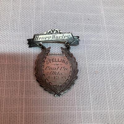 Sale Photo Thumbnail #274: Definitely a unique item! 1913 spelling bee pin with recipient's name engraved on it.