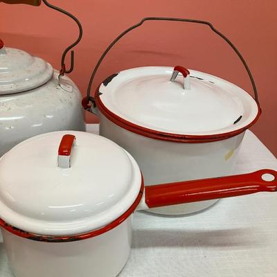 Sale Photo Thumbnail #312: 10 piece set of red/white enamel dishes including a baking dishes, slotted spoon, coffee pot, tea kettle, stock pot and other pot with lids