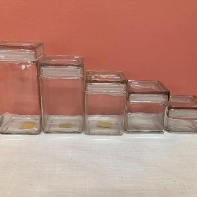 Sale Photo Thumbnail #327: Glass canister set with 5 sizes, all have sealing lids. No chips/cracks. Excellent condition.