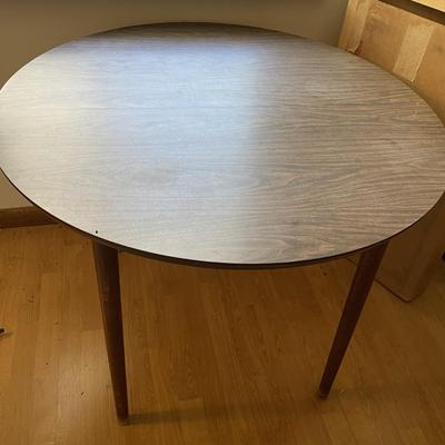 Sale Photo Thumbnail #183: The table measures approx. 39.25" in Diam. without leaf and leaf measures approx. 10" x 40", and table covers. Please see photos for more details.