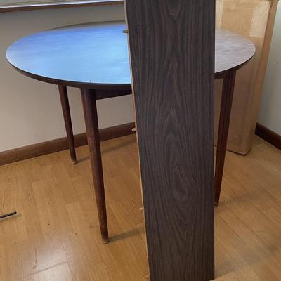 Sale Photo Thumbnail #181: The table measures approx. 39.25" in Diam. without leaf and leaf measures approx. 10" x 40", and table covers. Please see photos for more details.
