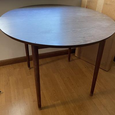 Sale Photo Thumbnail #182: The table measures approx. 39.25" in Diam. without leaf and leaf measures approx. 10" x 40", and table covers. Please see photos for more details.