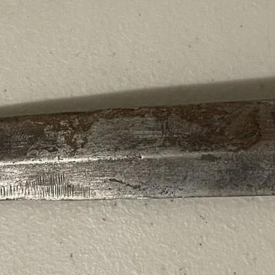 Sale Photo Thumbnail #219: The blade shows signs of age and possible wear. There are  metal bands wrapped around the handle with spaced dots which adds both texture and reinforcement, suggesting it was made with function in mind. Please see photos for more details.